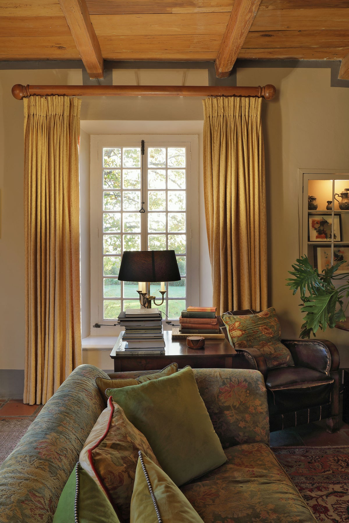 Manor House lounge with high ceilings and an original fireplace